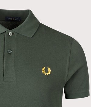 Fred Perry Polo Shirt in Green, shot at EQVVS. Detail shot. 