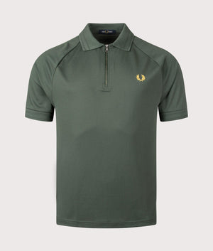 Fred Perry Zip Neck Polo Shirt in Court Green. Shot at EQVVS. Front shot. 