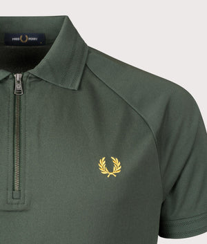 Fred Perry Zip Neck Polo Shirt in Court Green. Shot at EQVVS.  Detail shot. 