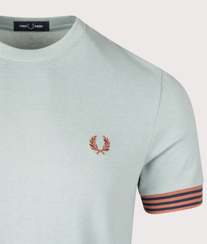 Striped Cuff T-Shirt in Silver blue by Fred Perry. Shot at EQVVS. Detail shot. 
