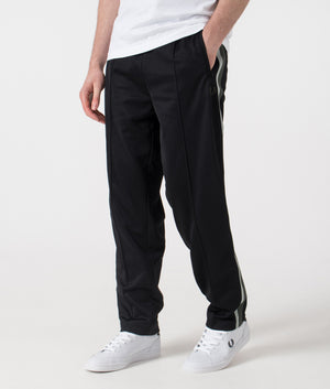 Fred Perry Two Colour Tape Track Pants in Black. Shot at EQVVS.  Side angle. 