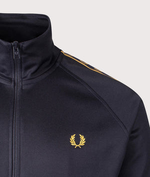 Fred Perry Contrast Tape Track Jacket in Navy/Honeycomb at EQVVS. Detailed logo shot.