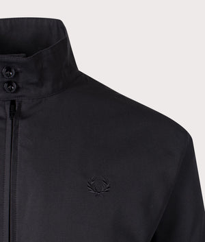 Fred Perry Made In England Harrington Jacket in 963 Midnight Blue. At EQVVS Menswear. Front logo shot. 