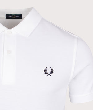 The Fred Perry Polo Shirt in White, 100% Cotton at EQVVS Lincoln. Detailed Logo Shot.