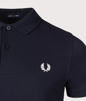 The Fred Perry Polo Shirt in Navy, 100% Cotton at EQVVS. Detailed Logo Shot. 