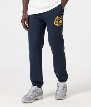 Billionaire Boy's Club Helmet Logo Joggers in Navy. Side angle model shot at EQVVS