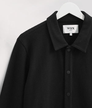 Wax London Hays Jersey Overshirt in Black. Detail Hanging Shot at EQVVS.