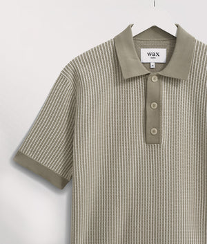 Wax London Turin Polo Shirt in light khaki at EQVVS. Detail Shot Hanging.