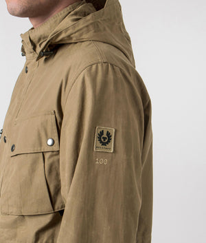 Belstaff Centenary Field Jacket in British Khaki, 100% Cotton at EQVVS. Centenary badge detail shot. 