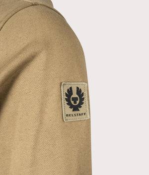 Belstaff Centenary Full Zip Sweatshirt in British Khaki, 100% Cotton at EQVVS. Detailed badge shot. 