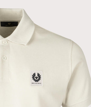 Belstaff Polo Shirt in Stone Beige, 100% Cotton. At EQVSS Menswear. Front logo shot.  