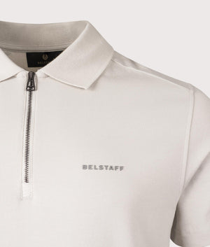 Belstaff Alloy Polo Shirt in Stone Beige. Shot at EQVVS. Detail shot. 