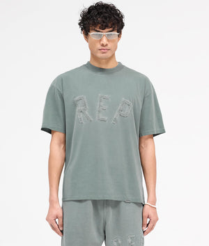 REPRESENT Rep Applique T-Shirt in Forest Green. Shot at EQVVS.  Front shot