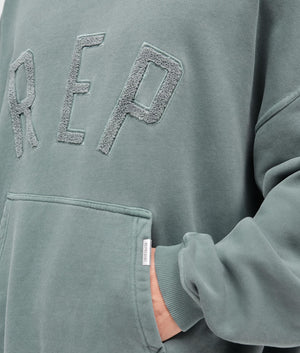 REPRESENT Rep Applique Hoodie in Forest Green. Shot at EQVVS. Detail shot. 