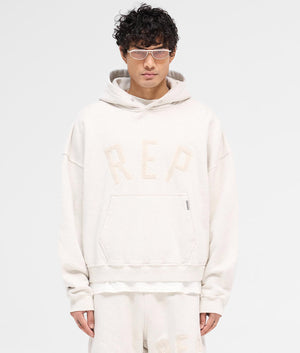 REPRESENT Rep Applique Hoodie in Cream Marl. Shot at EQVVS. Front shot. 