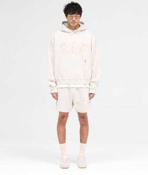 REPRESENT Rep Applique Hoodie in Cream Marl. Shot at EQVVS.  Full shot. 