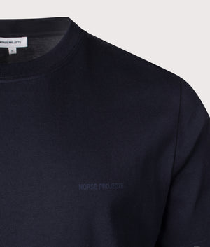 Norse Projects Johannes Organic NORSE Logo Print T-Shirt in Dark Navy. Shot at EQVVS.  Detail shot. 