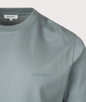 Norse Projects Johannes Organic NORSE Logo Print T-Shirt in Greyish Blue. Shot at EQVVS. Detail shot. 