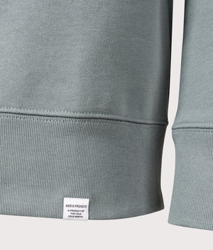 Norse Projects Relaxed Fit Ketel Quarter Zip Sweatshirt in Greyish Blue. Shot at EQVVS. Detail shot. 