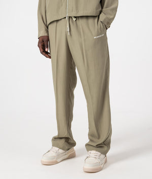 MKI Relaxed Fit Tencel Trousers in Sage Green. Side angle model shot at EQVVS.