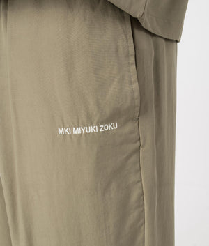 MKI Relaxed Fit Tencel Trousers in Sage Green. Detail angle model shot at EQVVS.