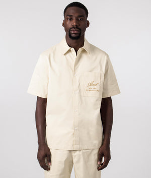 Axel Arigato Stitch Embroidered Short Sleeve Shirt in Pale Beige. Shot at EQVVS.  Front shot.