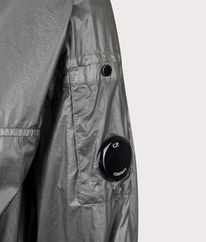 C.P. Company CS II Hooded Lens Jacket in Smoked Pearl at EQVVS. Detailed logo shot. 