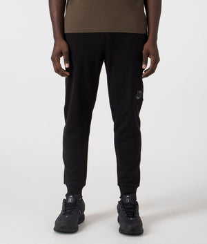 C.P. Company Diagonal Raised Lens Joggers in Black. Shot at EQVVS.  Front shot. 