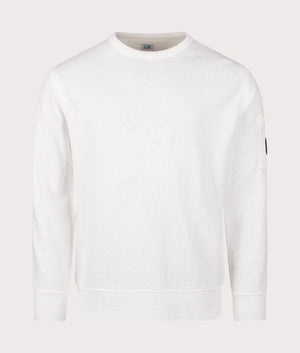 C.P. Company Lens Sleeve Crewneck Sweatshirt in Gauze White, 100% Cotton at EQVVS. Front shot. 