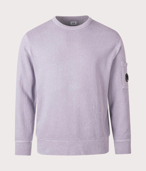 C.P. Company Lens Sleeve Crewneck Sweatshirt in Lavander Violet, 100% cotton at EQVVS. Front shot. 