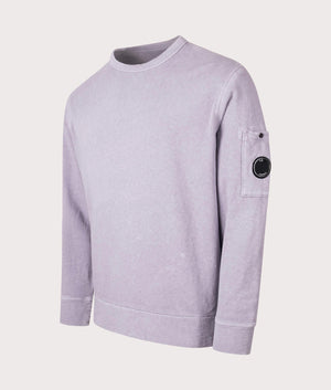 C.P. Company Lens Sleeve Crewneck Sweatshirt in Lavander Violet, 100% cotton at EQVVS. Side shot. 