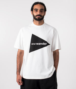 and wander logo t-shirt in white. Shot at EQVVS. Model front shot. 