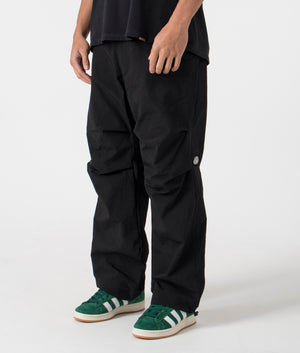 Root Flight Pants in Black by Pleasures. EQVVS Menswear Side Angle Model Shot. 