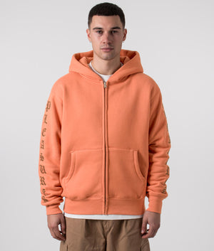 PLEASURES Relaxed Fit Old English Zip Up Hoodie in Rust, 100% Cotton. At EQVVS Menswear. Front model shot