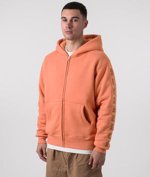 PLEASURES Relaxed Fit Old English Zip Up Hoodie in Rust, 100% Cotton. At EQVVS Menswear. Front side angle shot