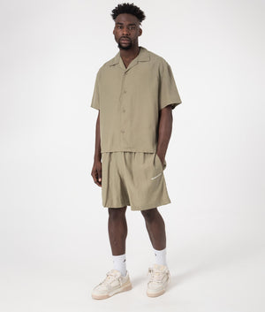 MKI Relaxed Fit Tencel Shorts in Sage Green. Full front angle model shot at EQVVS.
