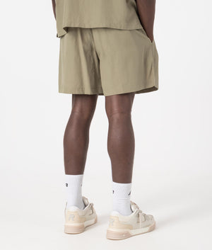 MKI Relaxed Fit Tencel Shorts in Sage Green. Back angle model shot at EQVVS.