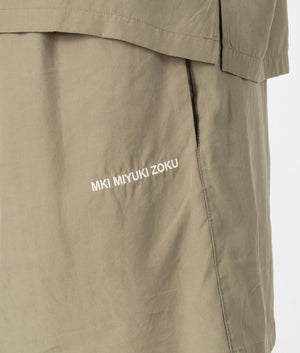 MKI Relaxed Fit Tencel Shorts in Sage Green. Detail angle model shot at EQVVS.