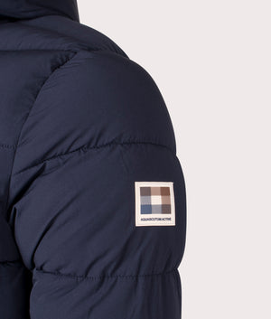 SP Hooded Puffer Coat in Navy by Aquascutum. Shot at EQVVS. Detail shot. 