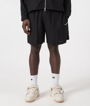MKI Relaxed Fit Tencel Shorts in Black. Front angle model shot at EQVVS.