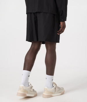 MKI Relaxed Fit Tencel Shorts in Black. Back angle model shot at EQVVS.