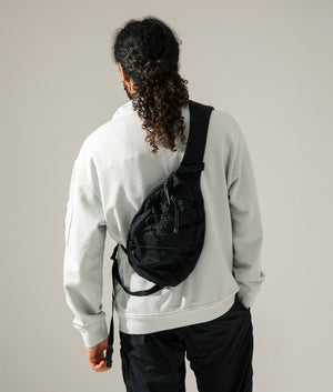 Nylon B Crossbody Rucksack in Black by C.P. Company at EQVVS. 