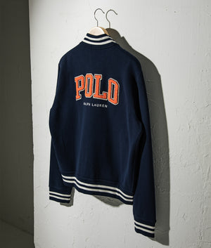 The RL Baseball Jacket in Cruise Navy by Polo Ralph Lauren at EQVVS. Campaign Shot.