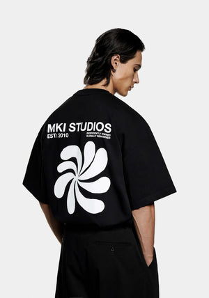 MKI Miyuki Zoku Abstract T-Shirt in Black. Shot at EQVVS.  Model back shot. 