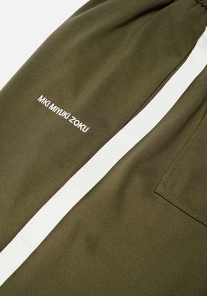 MKI Miyuki Zoku Olive Wide Fit Track Pants. Detail shot.