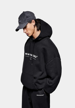 MKI Miyuki Zoku Linear Hoodie in Black. Shot at EQVVS.  Model front shot.