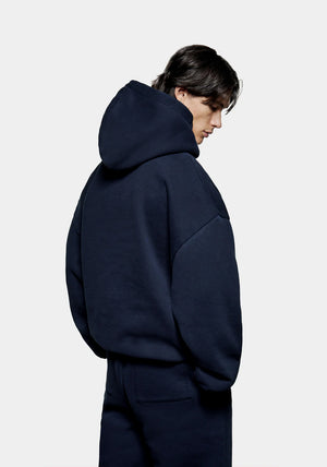 MKI Miyuki Zoku Uniform Hoodie in Navy. Shot at EQVVS. Model reverse shot. 