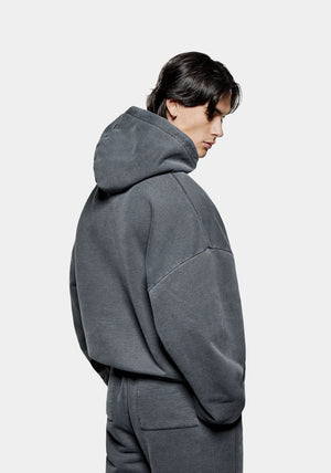 MKI Miyuki Zoku Uniform Hoodie in Pigment Black. Shot at EQVVS.  Model reverse shot. 