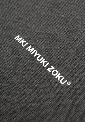 MKI Miyuki Zoku Uniform Hoodie in Pigment Black. Shot at EQVVS.  Detail shot. 