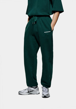 MKI Miyuki Zoku Uniform Joggers in Green. Shot at EQVVS. Front shot model. 